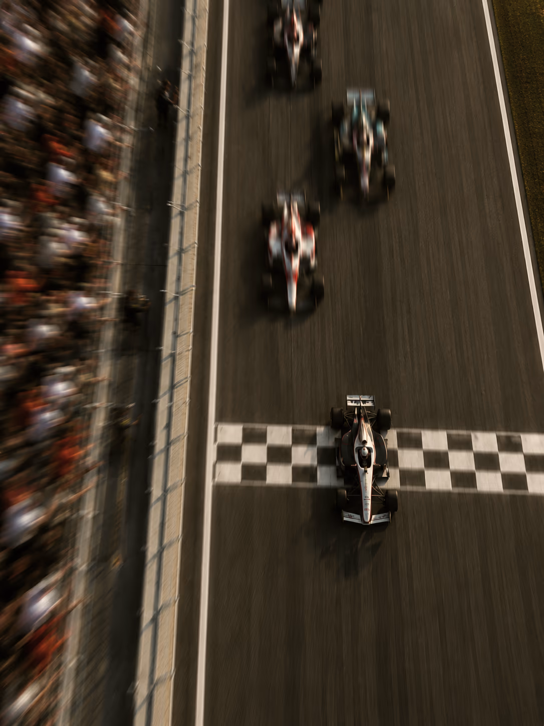 Race cars crossing a checkered finish line viewed from above.